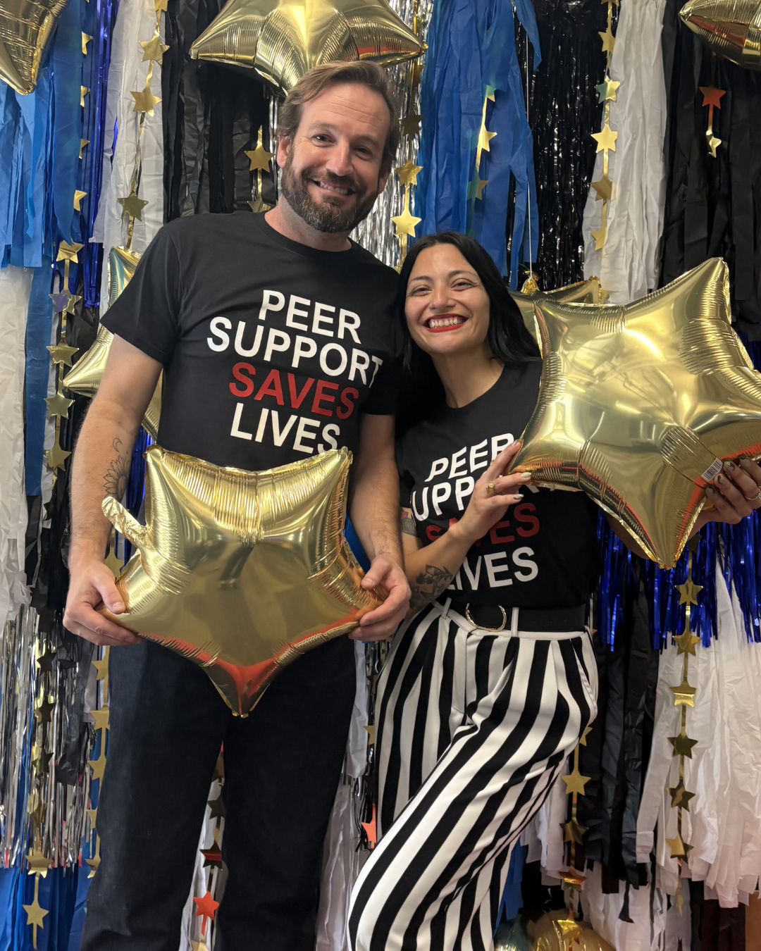 Friends in Peer Support Saves Lives tees holding star balloons